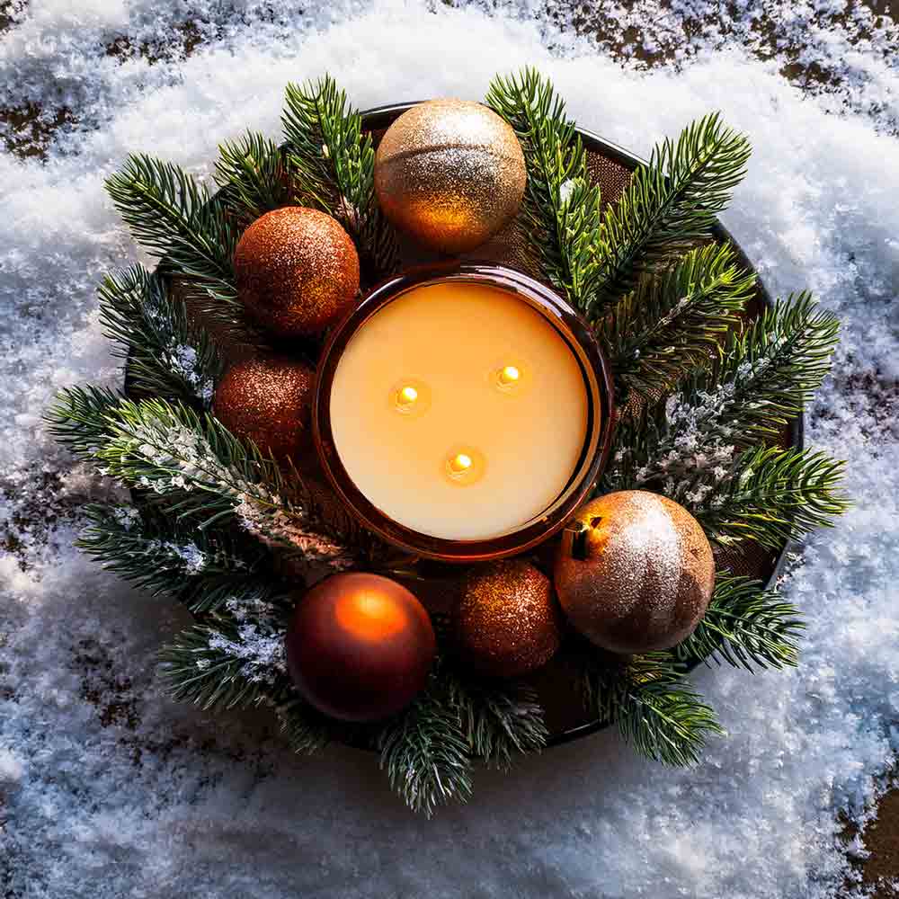 Winter candle by The Plant Workshop styled with festive lights and decorations