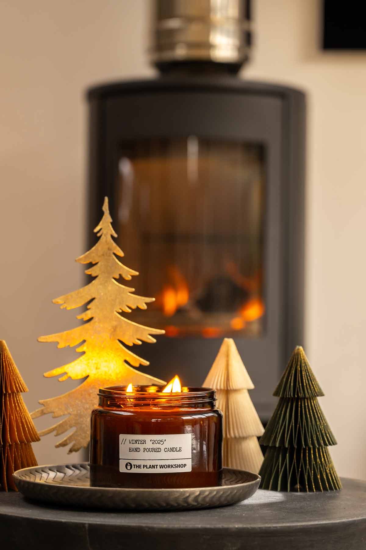 Winter Christmas candle by The Plant Workshop. Made in Scotland using eco-friendly ingredients with fast delivery across the UK. Christmas tree, fireplace, decorations, flickering candle and amber glass jar.