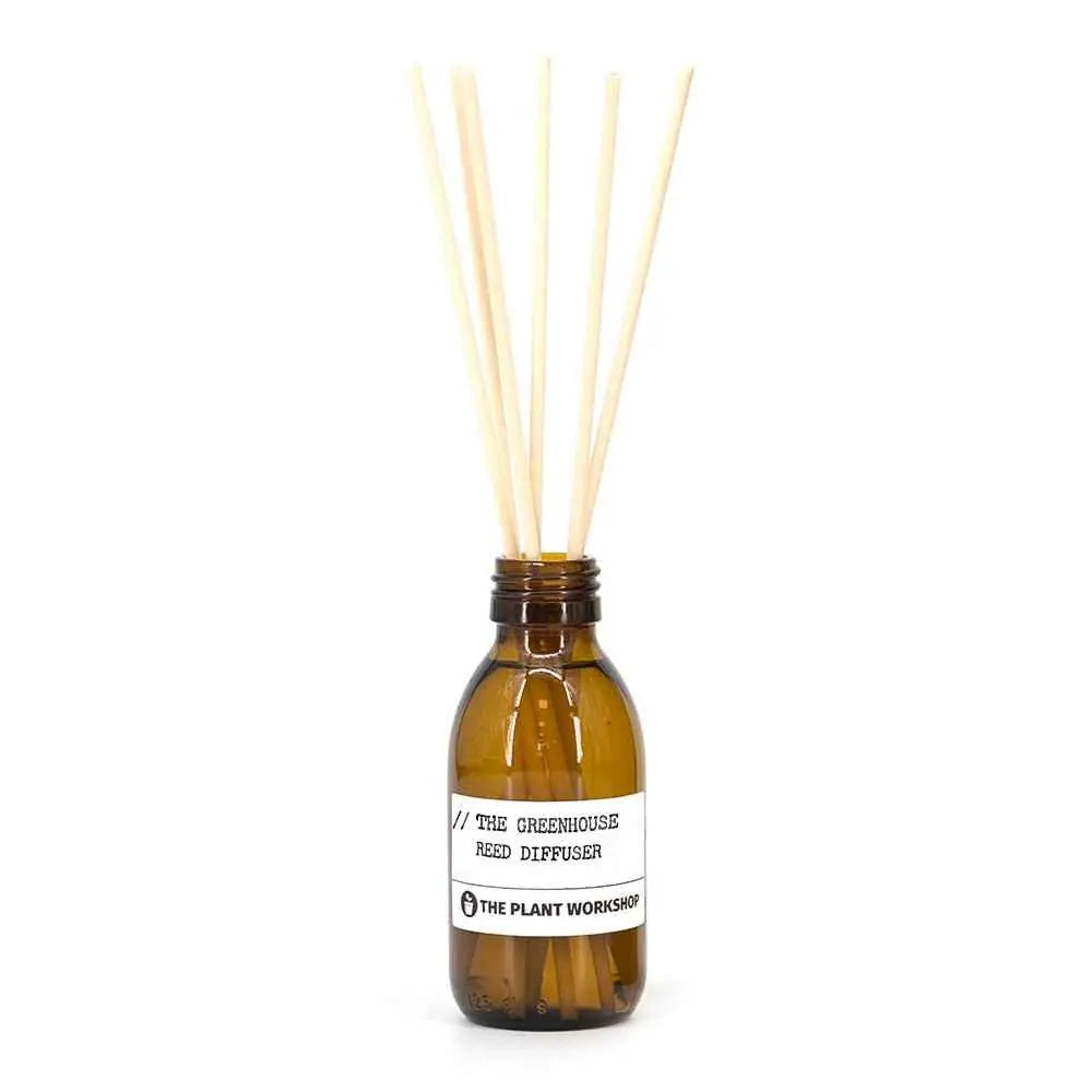 The Greenhouse Reed Diffuser in amber glass bottle with fibre reeds