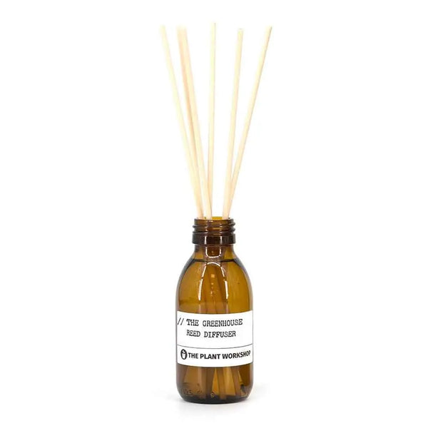 The Greenhouse Reed Diffuser in amber glass bottle with fibre reeds