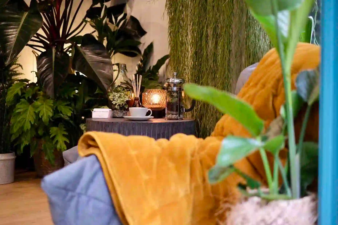 The Plant Workshop home fragrance styled with a fabric throw and coffee