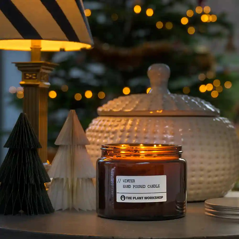Winter candle by The Plant Workshop styled with festive lights and decorations